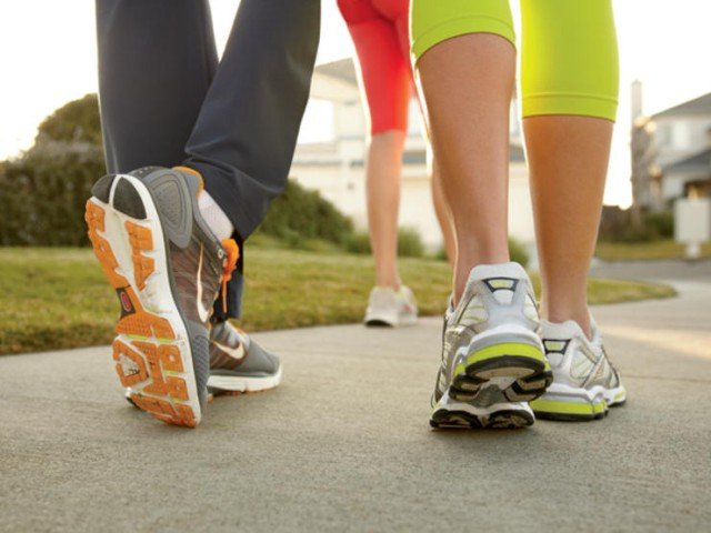 close up of sneakers walking on pavement