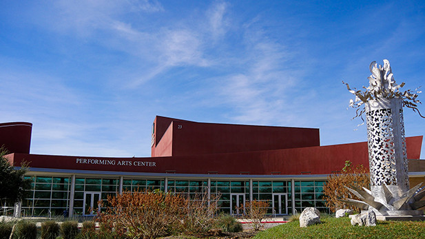 Performing arts Center at Alamo Colleges. A blue sky and a sculpture on the campus.