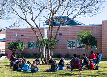 Students gather on the front lawn.