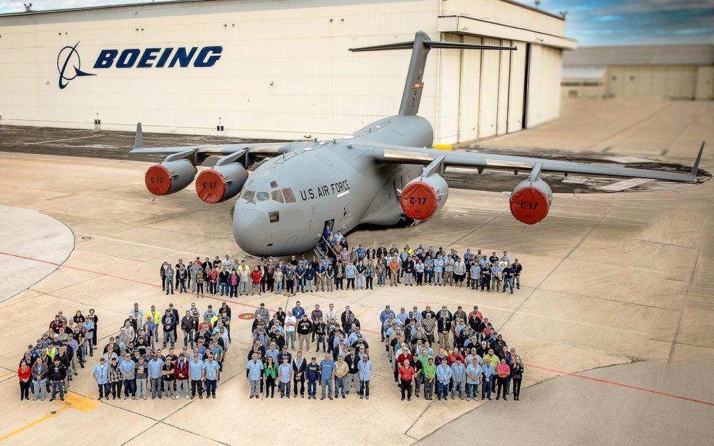 Numerous staff pose in front of a Boeing U.S. Air Force airplane.