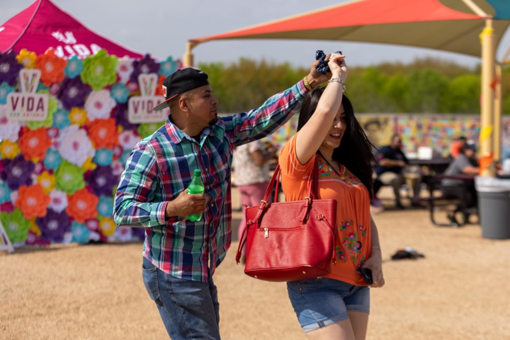 dancing couple at the VIDA event plaza during TAMU Festival de Cascarones