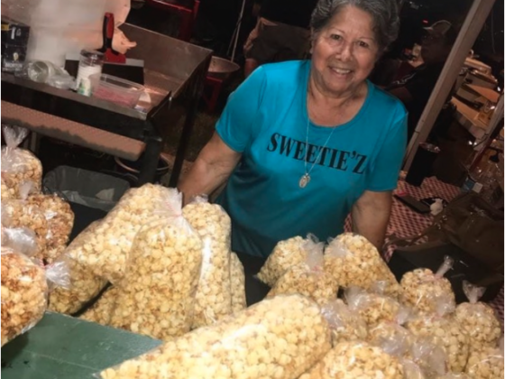 Maria Soto of Sweetie'z Kettle Corn poses with her popcorn for Vida MAkers and Shakers