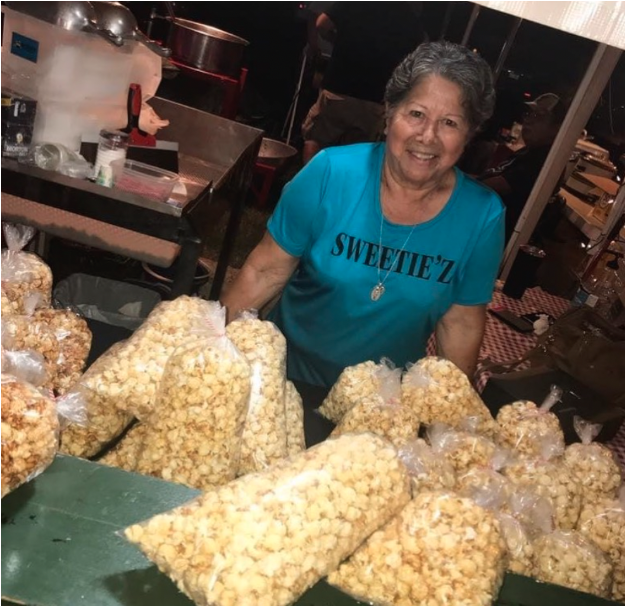 business owner making bags of popcorn
