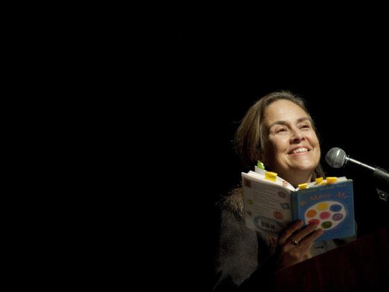 Naomi Shihab Nye reads her book into microphone