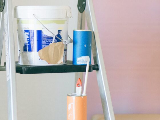 Paint bucket and brushes on a stool