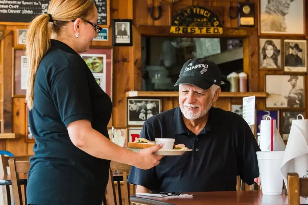 A waiter serves a guest at B&B Smokehouse, San Antonio.