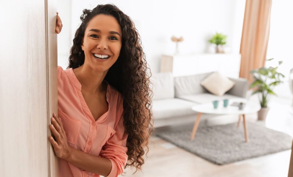 Young Woman Opens the Front Door to her bright, new, modern townhome at VIDA San Antonio