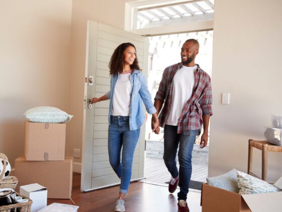 A couple walk into their new apartment at Los Arcos at Vida San Antonio.