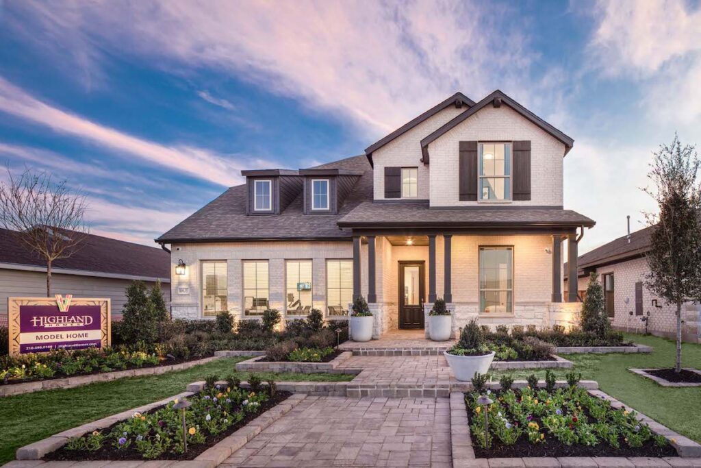 A pink sunset sets against a blue sky with a Highland homes model home at VIDA San Antonio.