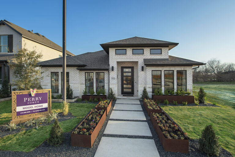 Perry Homes Model Home at VIDA, A Contemporary, Single Floor Model Home against a blue sky with green grass in the front yard