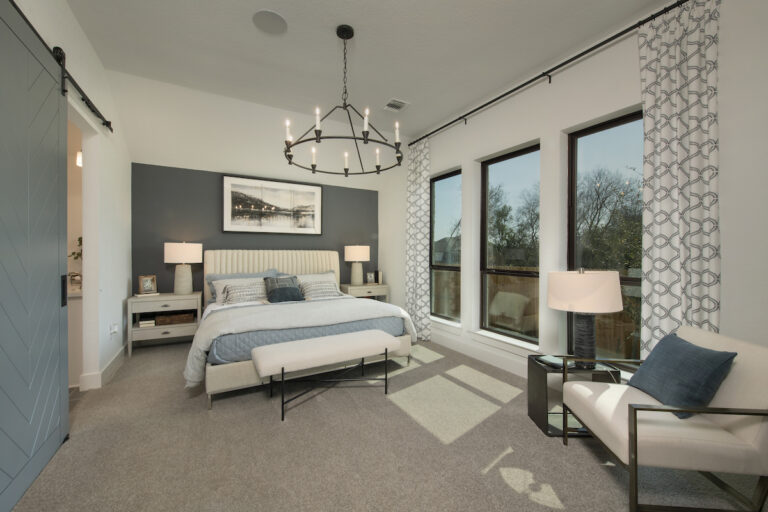 A Large carpeted master bedroom decorated and designed by Perry Homes