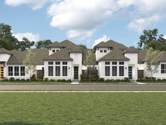 A line of new, contemporary townhomes painted white against a blue sky at VIDA San Antonio