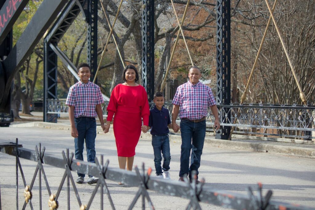 Principal Roxie Freeman Poses with her husband and two sons