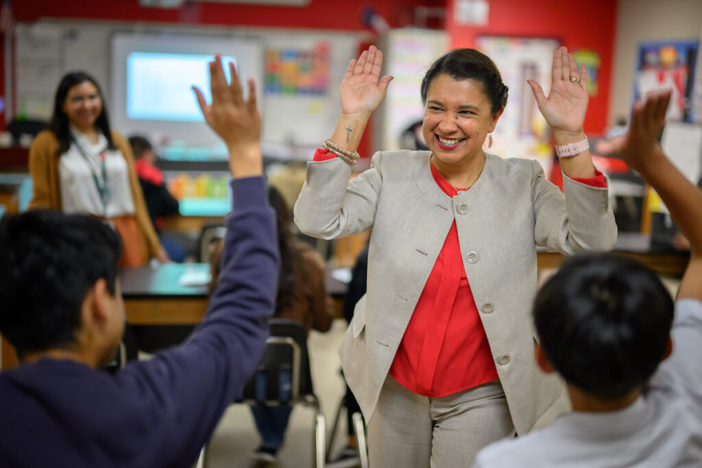 Roxie Freeman high fives students