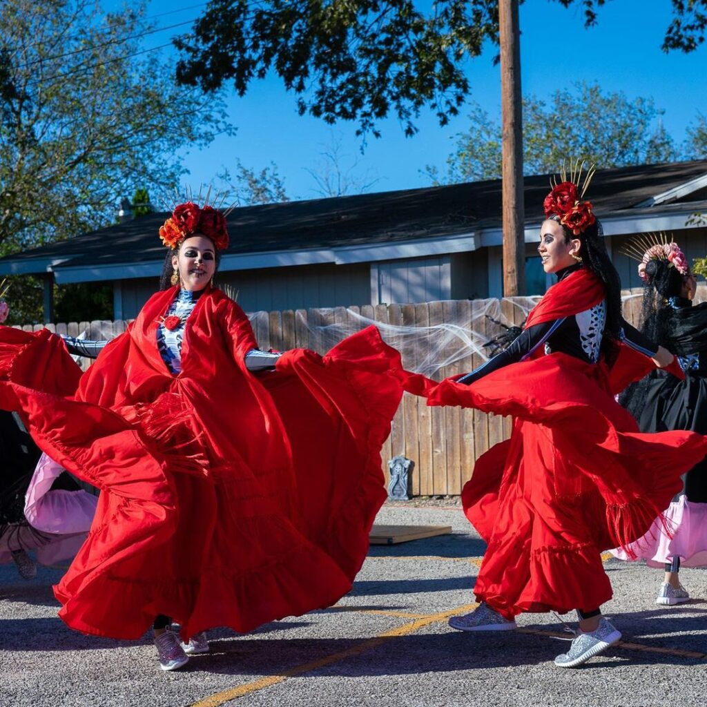 folklorico dancers perform in dia de los muertos outfits