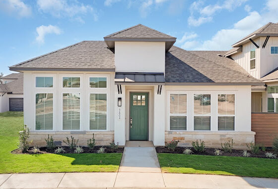 A gorgeous townhome with a green door.