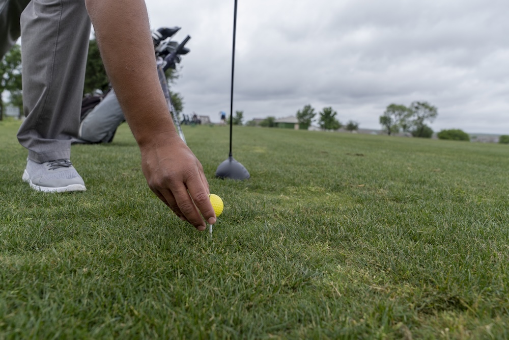 Ray Garza tees up a golf ball on the Mission del Lago golf Course