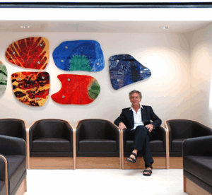 Artist Martin Donlin sits in row of chairs