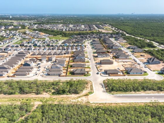 A bright sunny day from a bird's eye view, the VIDA San Antonio community has vastly expanded, showing numerous homes completed and in progress.