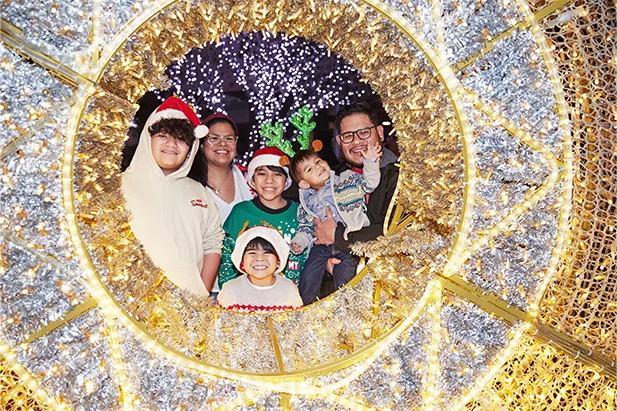 a family enjoys winter lights during the holidays