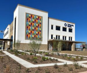 A modern colorful mural can be seen on the side of the new University Health Vida clinic building