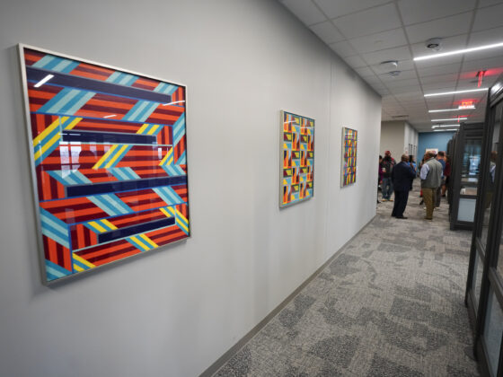 A row of colorful mural paintings can be seen on a wall inside the University Health Vida clinic