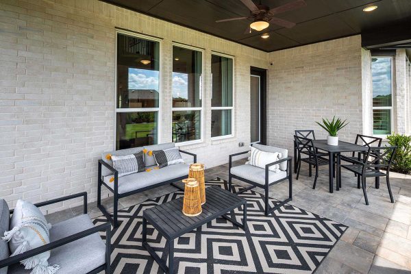 Outdoor Patio with fun, black, modern patio furniture designed by Highland Homes at VIDA San Antonio