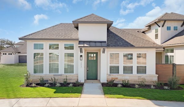 A gorgeous townhome with a green door.