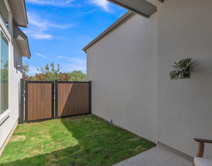 Townhome backyard with grass and fence