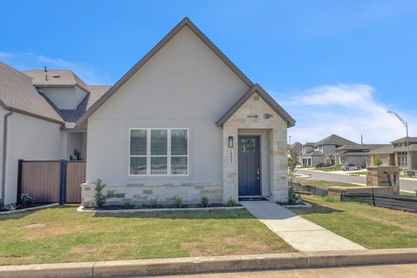 A new build exterior of a Sitterle townhome with a green lawn in the front