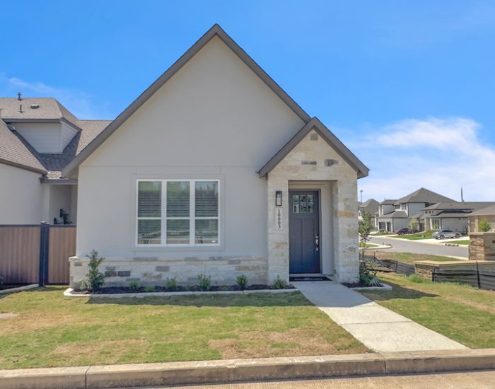 A new build exterior of a Sitterle townhome with a green lawn in the front